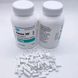 Xanax XR medication, each containing 2 mg of alprazolam. The bottles are white with green and blue labeling that specifies the product as "Xanax XR 2 mg extended-release tablets.