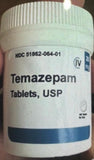 A bottle of Temazepam tablets, USP with a label indicating it is a controlled substance.